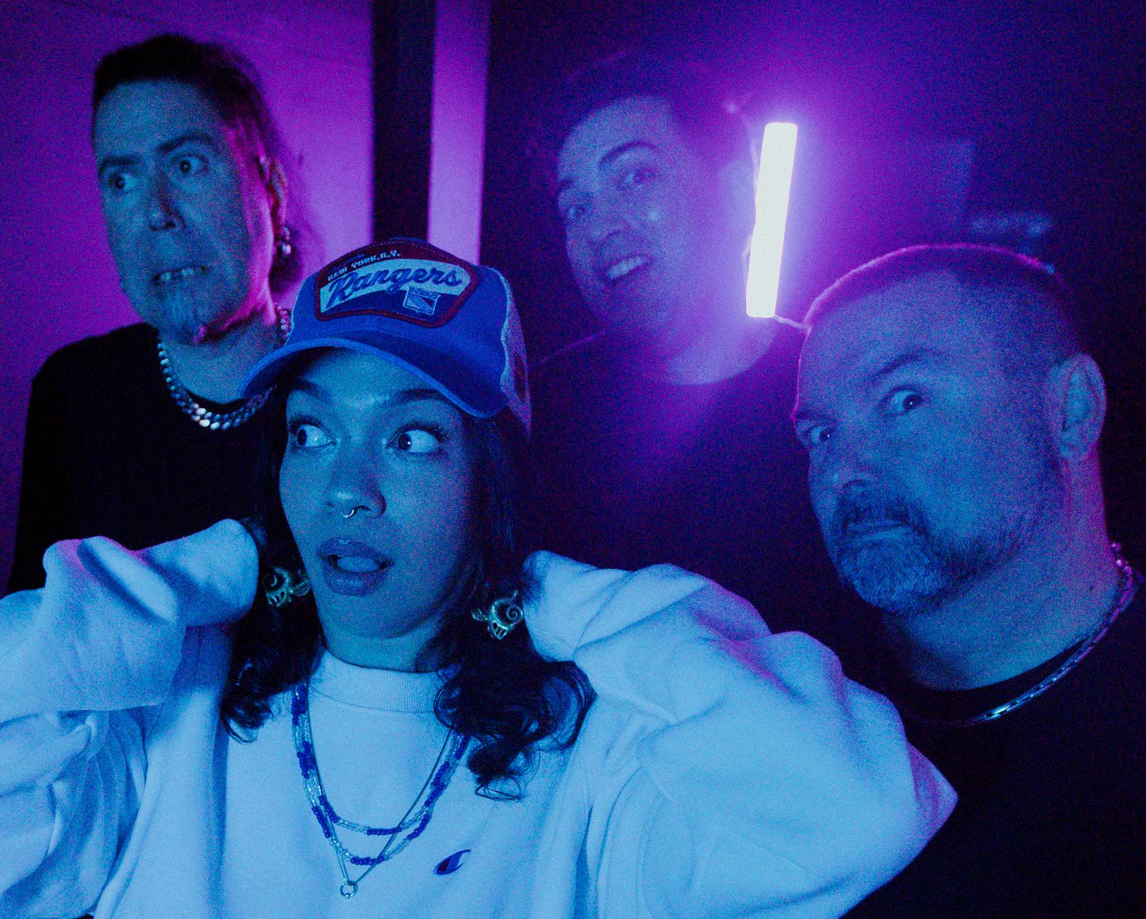 Diablura, the four-piece metal band, lit in purple and blue neon